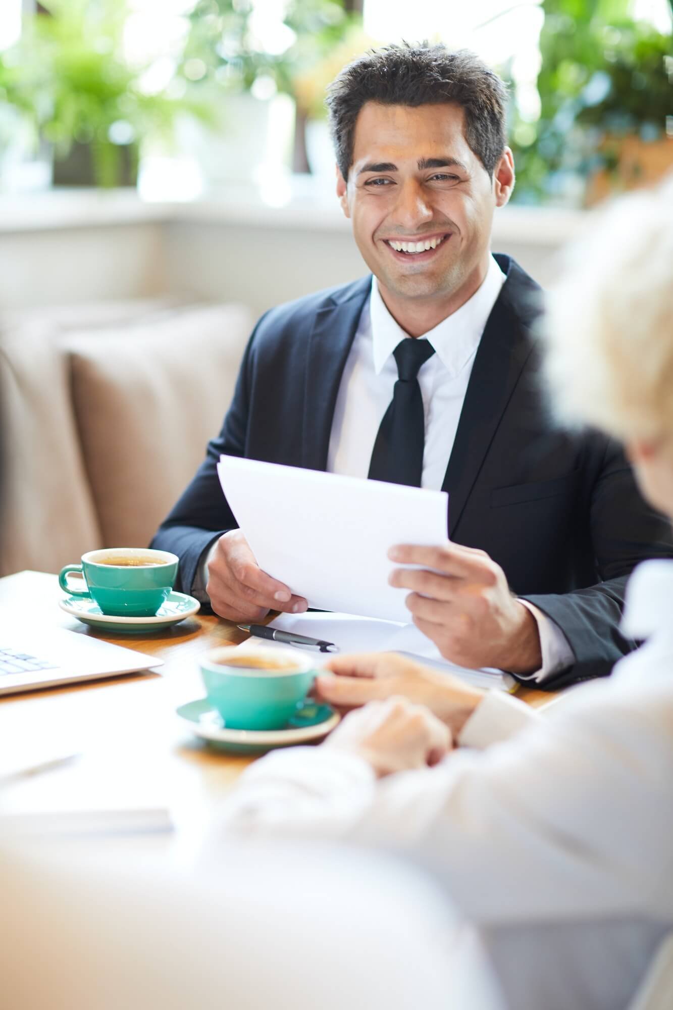 cheerful-lawyer-talking-to-client-in-cafe-1.jpg